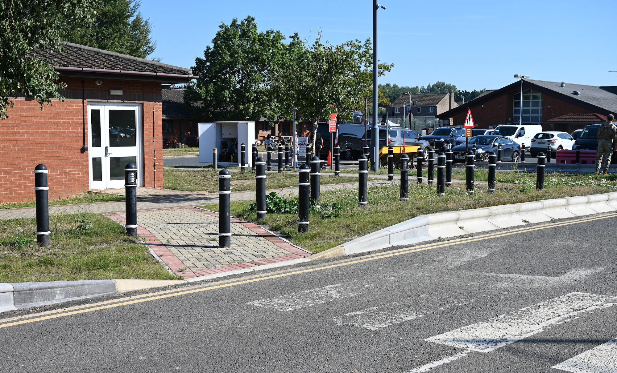 New drop curbs and block paving pathway replace older curbs and pathways outside the child development center at Royal Air Force Mildenhall, England, Sept. 7, 2023. As part of a base initiative to increase safety for CDC families, U.S. Air Force Airmen from the 100th Civil Engineer Squadron Heavy Equipment and Pavements shop, otherwise known as the “Dirt Boyz,” put up new fencing, replace curbs and added a concrete mini hardstand for an additional 100th Security Forces Squadron entry control point to provide easier and safer access for those walking across the main road from base to the CDC gate. (U.S. Air Force photo by Karen Abeyasekere)