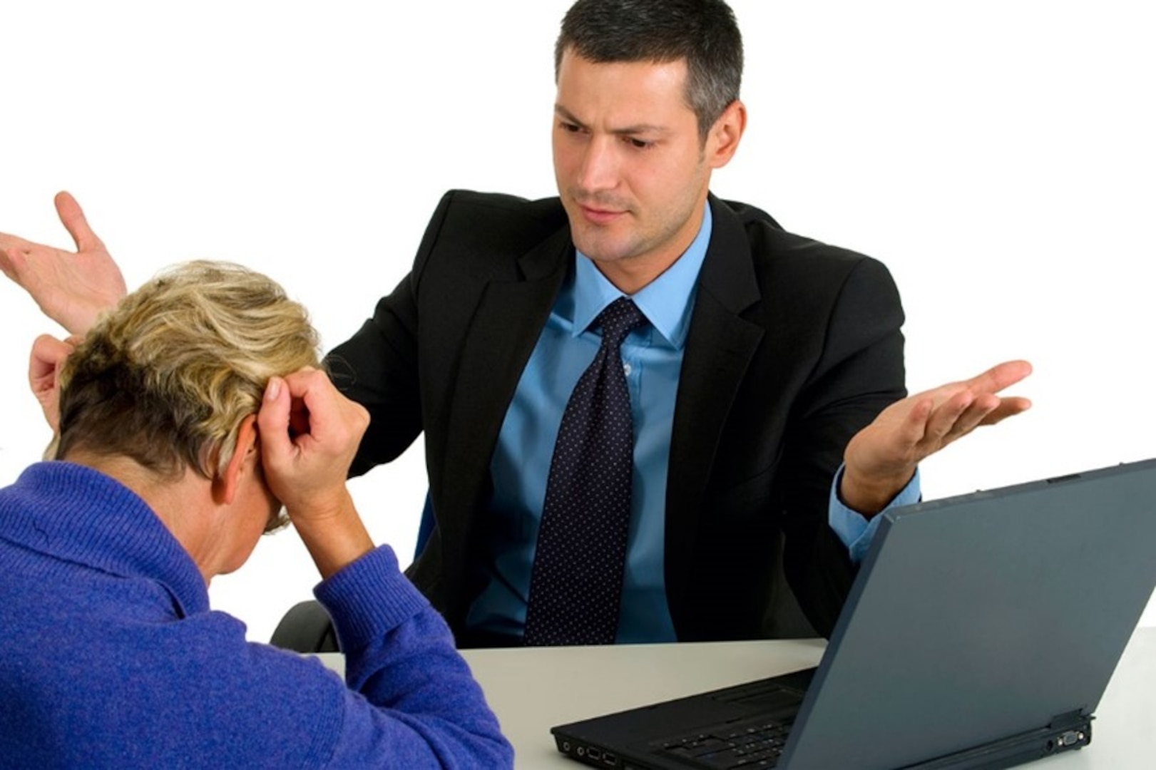 Man in suit frustrated with women in blue sweater.