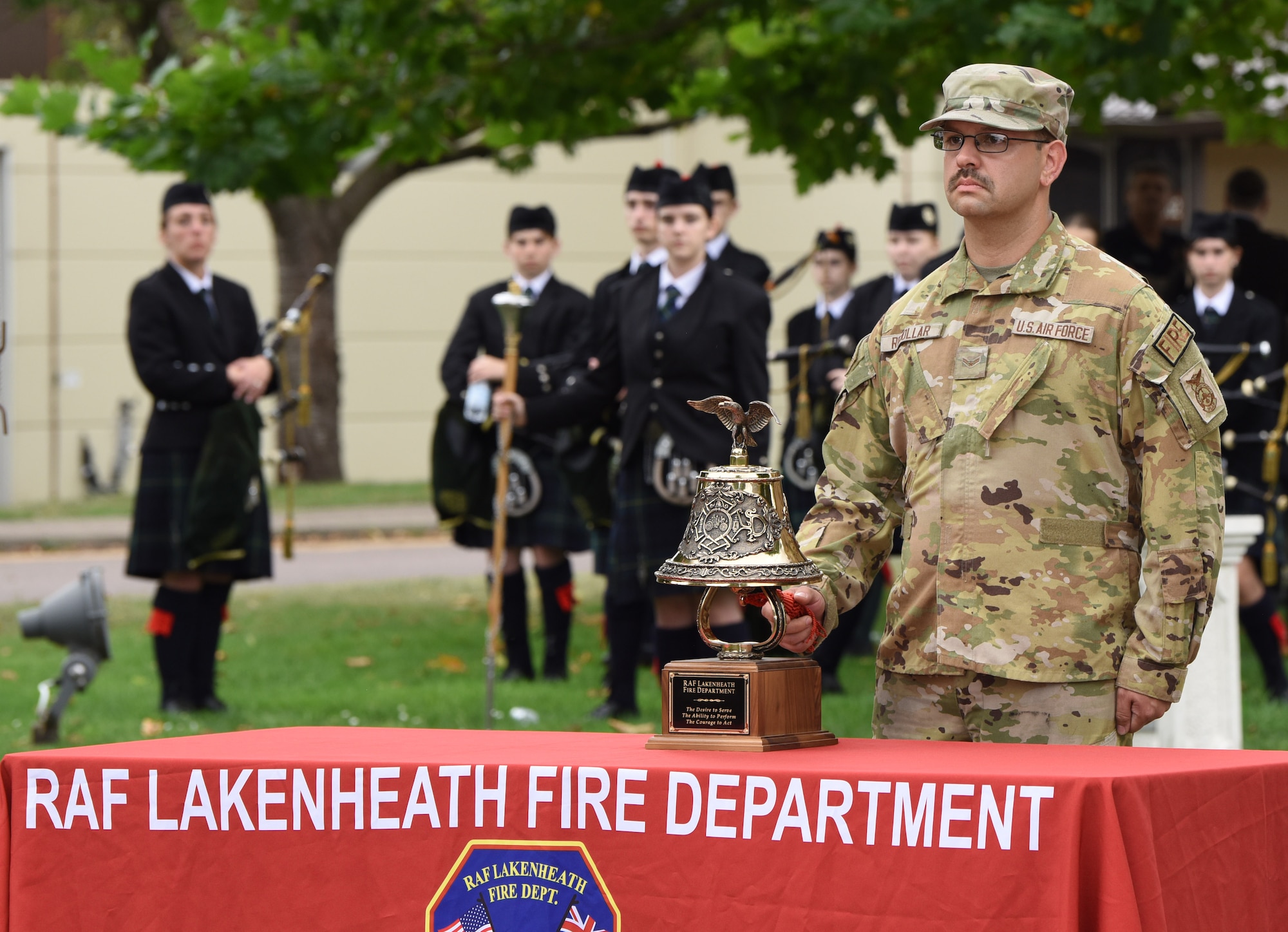 U.S. Air Force Senior Airman Emmanuel Rebollar, 48th Civil Engineer Squadron Fire Department, rings the ceremonial bell during the 9/11 remembrance ceremony at Royal Air Force Lakenheath, England, Sept. 11, 2023. The Tolling of the Bell ceremony is a tradition dating back to when firefighters began their day’s shift. The alarm – sounded by the bell – summoned those brave souls to fight fires and save lives. When the fire was out and the alarm was over, it was the bell which signaled they had answered the call. When a firefighter paid the supreme sacrifice, it was the mournful toll of the bell which announced the comrade’s passing. (U.S. Air Force photo by Karen Abeyasekere)