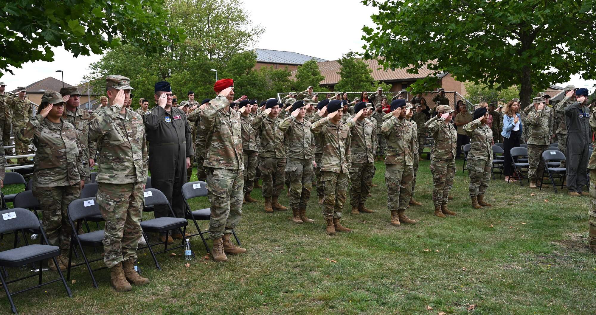 U.S. Air Force leadership Airmen, civilians and families from Royal Air Force Mildenhall and RAF Lakenheath salute during the playing of the national anthem at the 9/11 memorial ceremony at RAF Lakenheath, England, Sept. 11, 2023. The ceremony honored the fallen from the Sept. 11 terrorist attacks and marked the 22nd anniversary of the tragic events, from which there was almost 3,000 victims. (U.S. Air Force photo by Karen Abeyasekere)