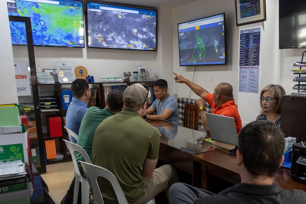 Philippine and U.S. service members speak with Municipal Disaster Risk Reduction Management Office leadership during Balikatan 23 in the Province of Antique, Philippines, April 18, 2023.