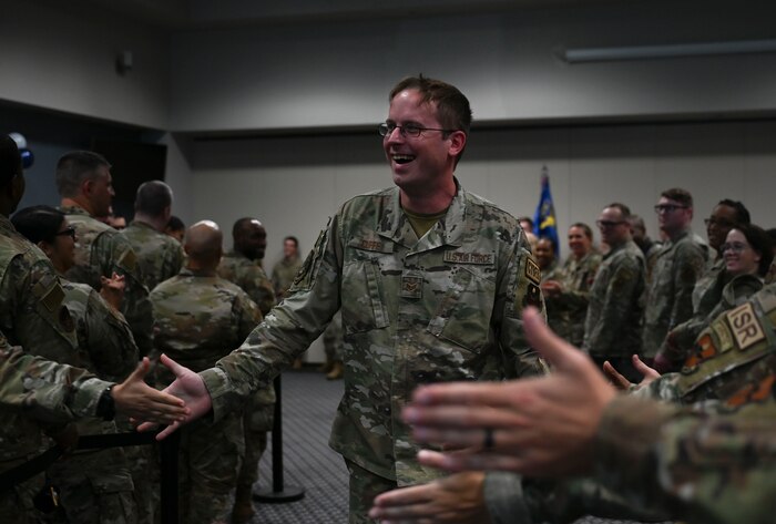 U.S. Air Force Senior Airman Dane Cuffe, 17th Communications Squadron project manager, makes his way through the gauntlet, receiving fist bumps from noncommissioned officers during the Staff Sergeant Release Party at the Powell Event Center, Goodfellow Air Force Base, Texas, Sept. 8, 2023. Cuffe and other 17th Training Wing Senior Airmen selected to the rank of staff sergeant will make the transition to NCO in the coming months. (U.S. Air Force photo by Airman 1st Class Madison Collier)