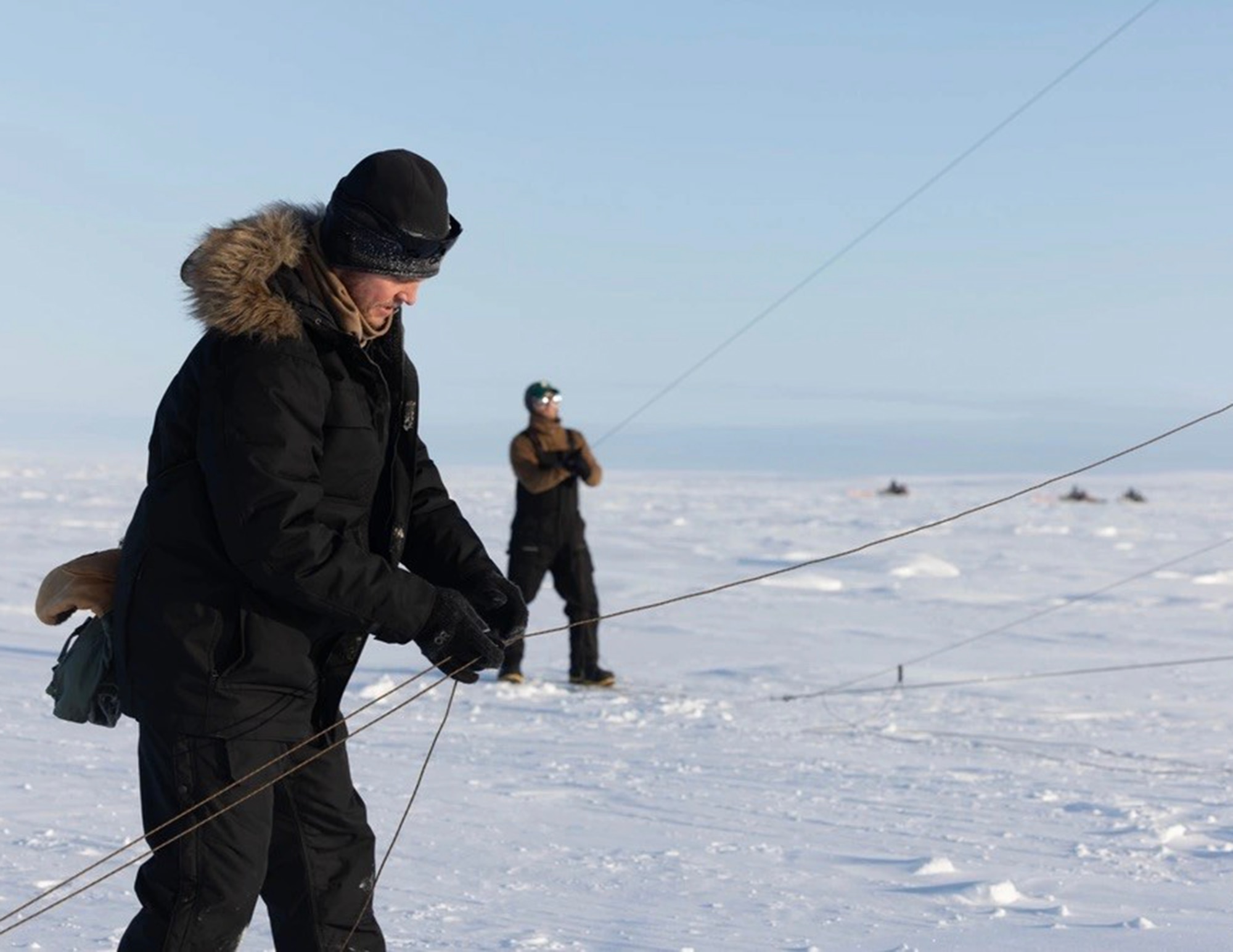 U.S. Air Force Master Sgt. Brian Shuey and Cody Hallas, 133rd Contingency Response Flight, set up a 50-foot CSA “Carrymast” CTM15 Comm mast with UHF and VHF antennas in Resolute Bay, Nunavut, Canada, March 10, 2023.