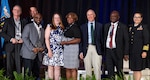 Defense Health Agency’s leaders presented awards to three DHA teams for their work in auditability compliance, cyber security, and rationalization/alignment of resources in military hospitals and clinics at the 2023 Defense Health Information Technology Symposium on Aug. 8. Pictured from the left; Kevin Griffin, deputy chief information officer at Evans Army Community Hospital; Pat Flanders, program executive officer medical systems/chief information officer for the DHA; James Laster, chief information officer at Irwin Army Community Hospital; Tonya Reeder, CIO, Walter Reed National Military Medical Center; Sharon Opel, chief technology officer, WRNMMC; DHA Deputy Director Dr. Michael Malanoski; Stephen Ngeke, division chief of infrastructure and operations, WRMMC; and U.S. Public Health Service Capt. Ivonne Arena, deputy chief information officer.