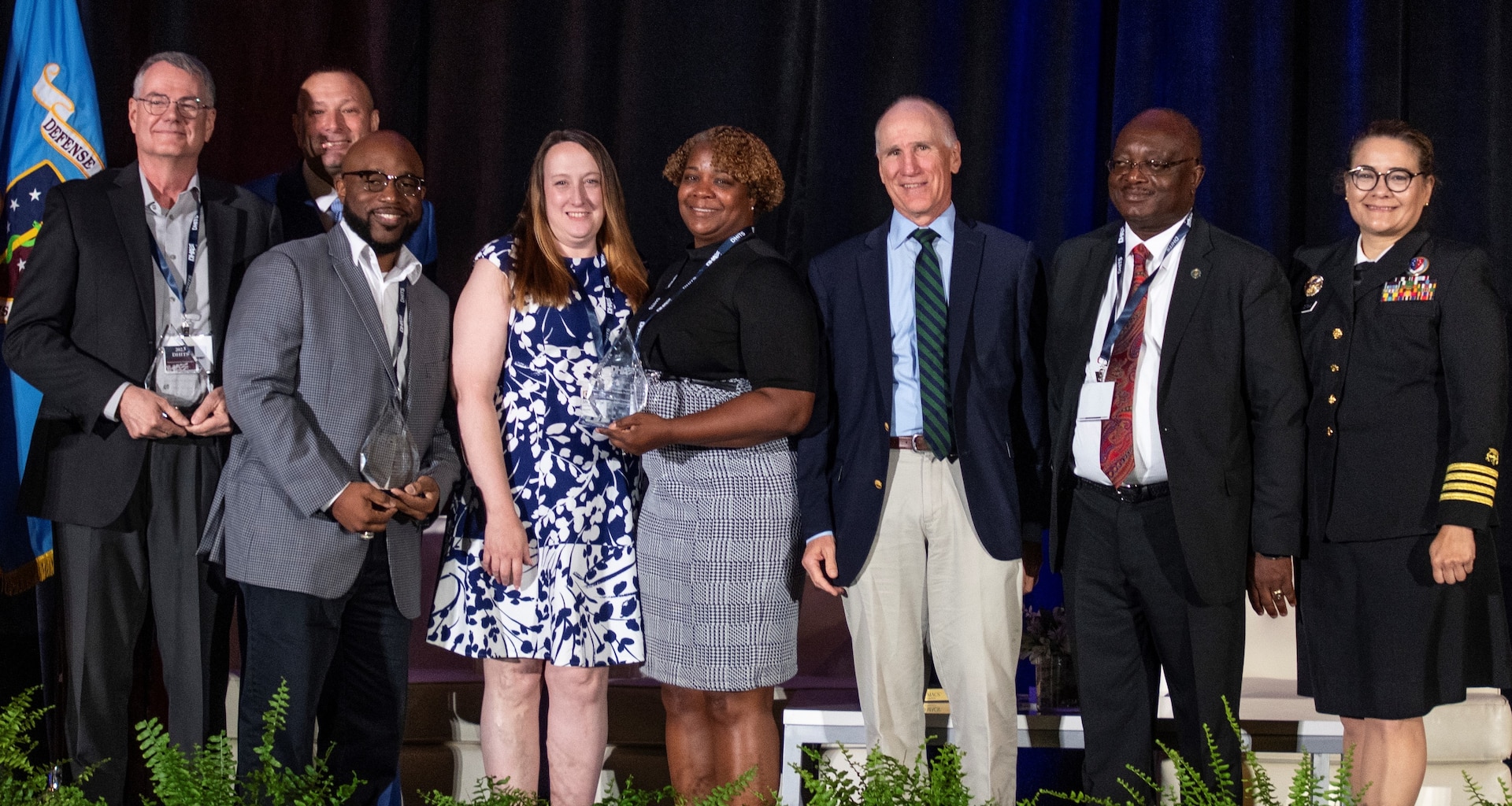 Defense Health Agency’s leaders presented awards to three DHA teams for their work in auditability compliance, cyber security, and rationalization/alignment of resources in military hospitals and clinics at the 2023 Defense Health Information Technology Symposium on Aug. 8. Pictured from the left; Kevin Griffin, deputy chief information officer at Evans Army Community Hospital; Pat Flanders, program executive officer medical systems/chief information officer for the DHA; James Laster, chief information officer at Irwin Army Community Hospital; Tonya Reeder, CIO, Walter Reed National Military Medical Center; Sharon Opel, chief technology officer, WRNMMC; DHA Deputy Director Dr. Michael Malanoski; Stephen Ngeke, division chief of infrastructure and operations, WRMMC; and U.S. Public Health Service Capt. Ivonne Arena, deputy chief information officer.