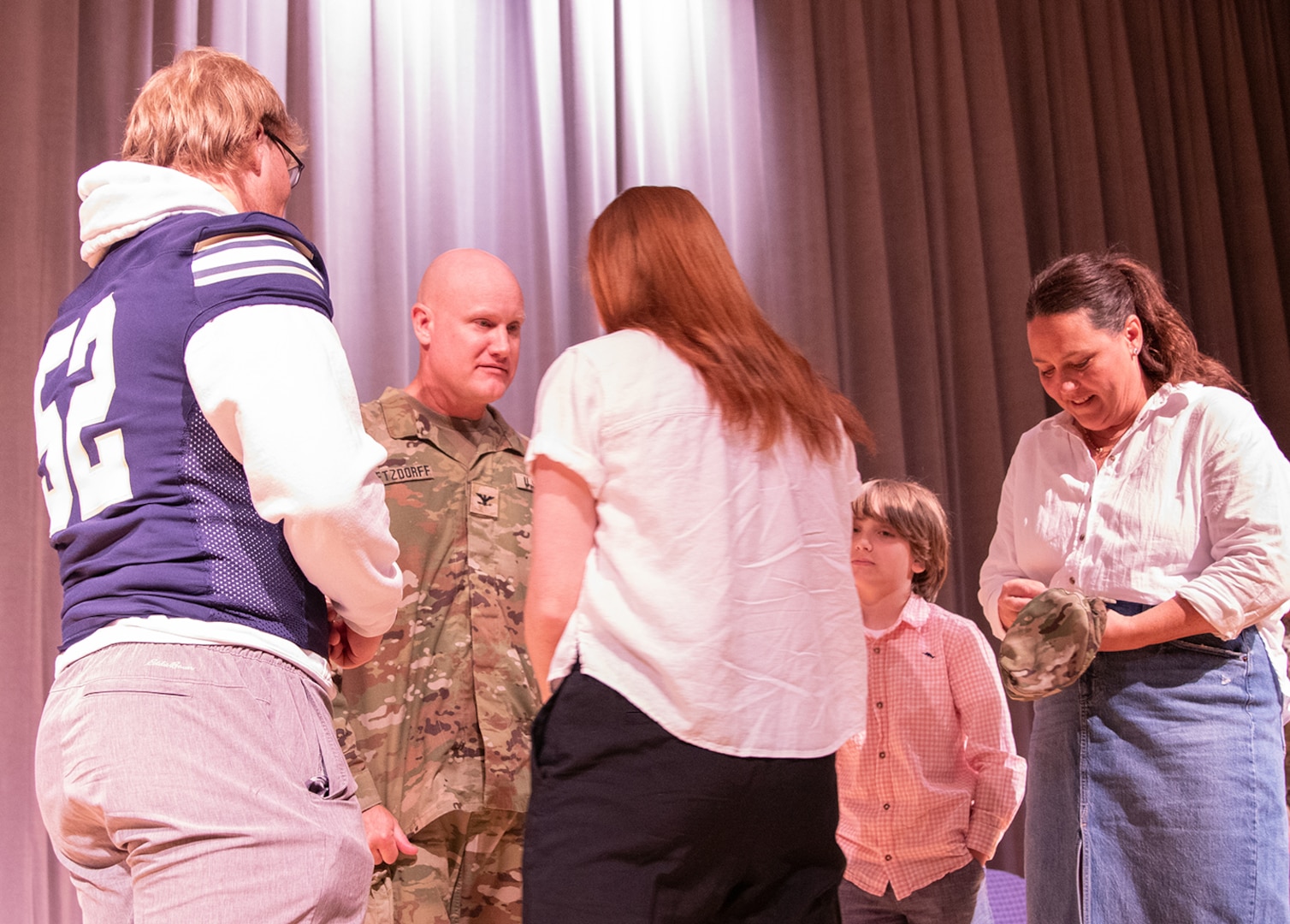 The family of newly promoted Illinois Army National Guard Col. Paul Metzdorff, including wife, Alyson, and children, Isabella, Jackson, and Cooper, secure new rank during a ceremony Sept. 8 at the Astroth Community Education Center, Heartland Community College, Normal, Illinois.