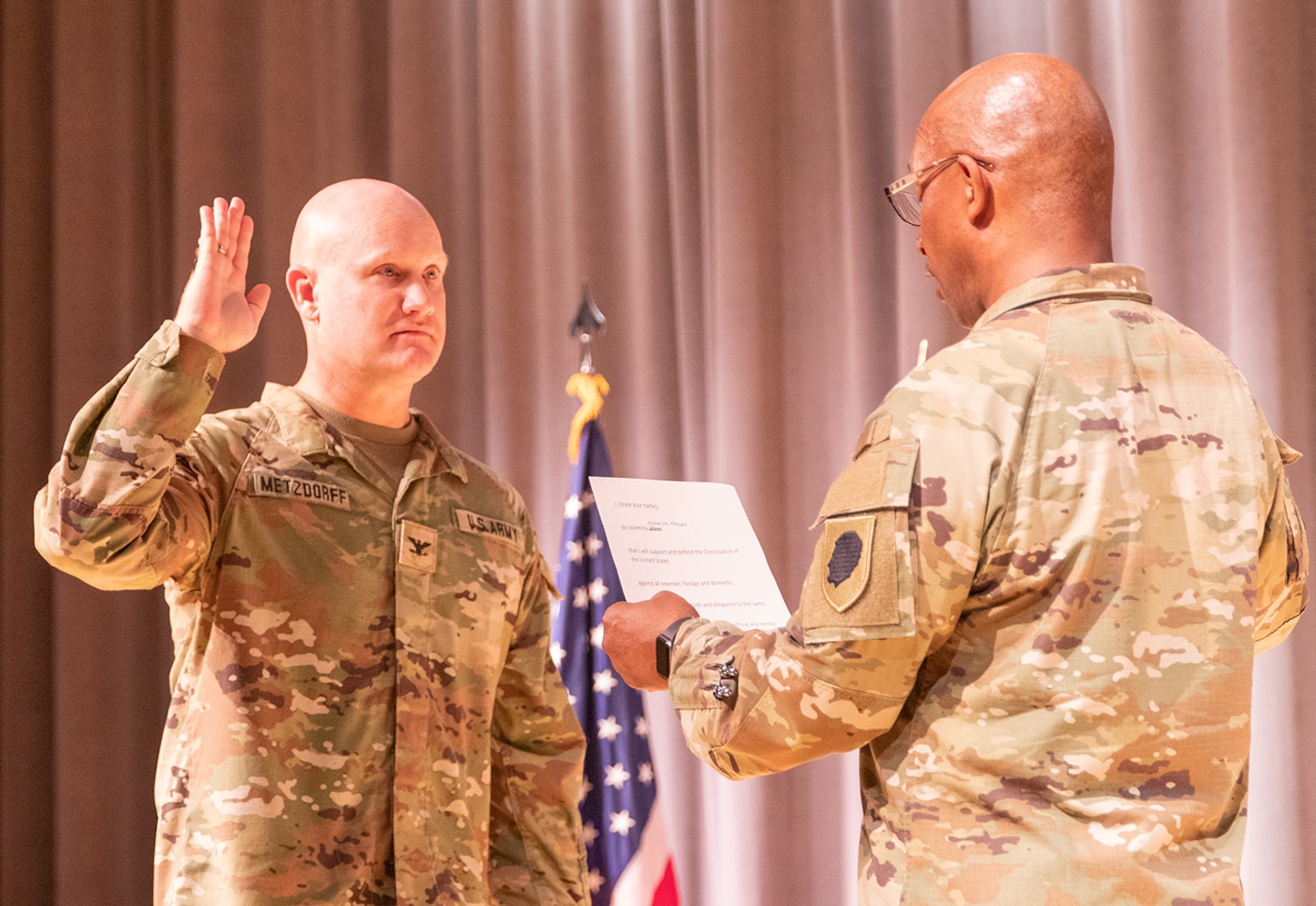 Newly promoted Illinois Army National Guard Col. Paul Metzdorff is administered the oath of office by Maj. Gen. Rodney Boyd, Assistant Adjutant General – Army and Commander of the Illinois Army National Guard, Sept. 8 during a promotion ceremony at the Astroth Community Education Center, Heartland Community College, Normal, Illinois.