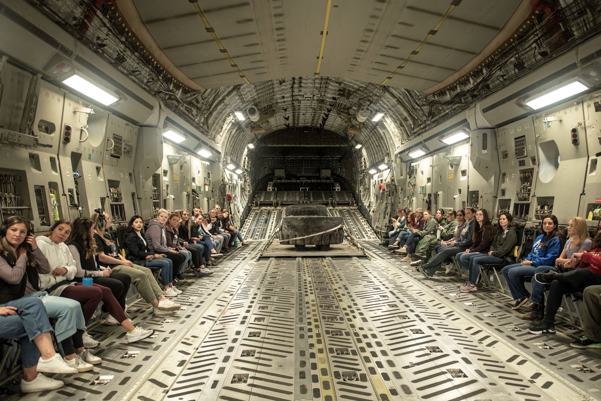 Team McChord spouses await takeoff on a C-17 Globemaster III during the annual spouses orientation flight at Joint Base Lewis-McChord, Washington, Sept. 9, 2023. Before the flight, spouses were given a safety briefing by a loadmaster as well as a timeline for the flight. (U.S. Air Force photo by Airman 1st Class Kylee Tyus)
