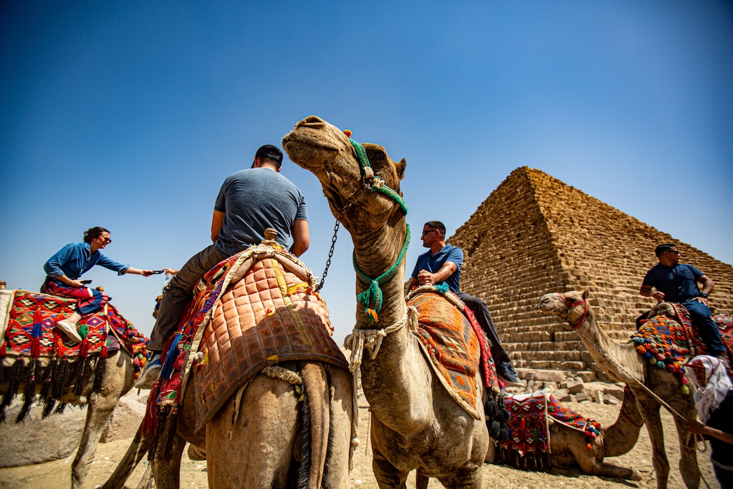 U.S. Marines with 1st Civil Affairs Group, Force Headquarters Group, Marine Forces Reserve ride camels around the pyramids on a tour for cultural day during exercise Bright Star 23 at Giza, Egypt, Sept. 8, 2023. Bright Star 23 is a multilateral U.S. Central Command exercise held with the Arab Republic of Egypt across air, land, and sea domains that promotes and enhances regional security and cooperation, and improves interoperability in irregular warfare against hybrid threat scenarios. (U.S. Marine Corps Photo by Capt. Mark Andries)