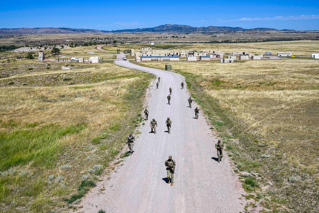 Airmen march on a road.