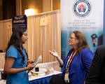 DoD Manufacturing Technology Program Director, Tracy Frost, speaks with an Emerging Technologies for Defense Conference and Exhibition attendee at the ManTech expo booth, August 29, 2023.