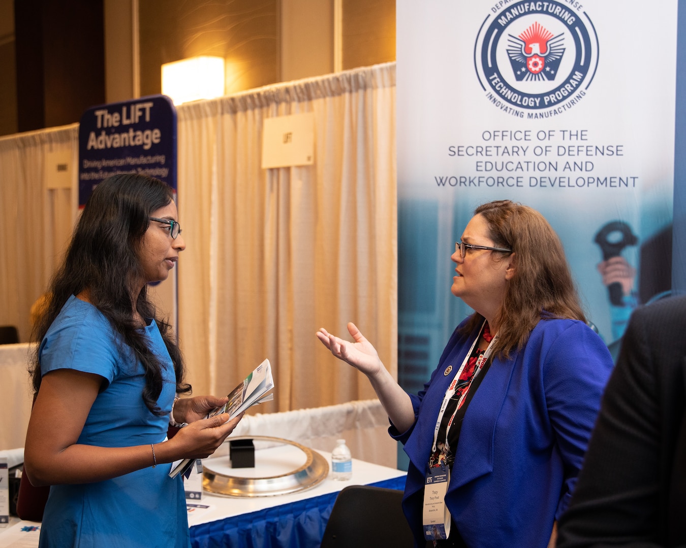 DoD Manufacturing Technology Program Director, Tracy Frost, speaks with an Emerging Technologies for Defense Conference and Exhibition attendee at the ManTech expo booth, August 29, 2023.