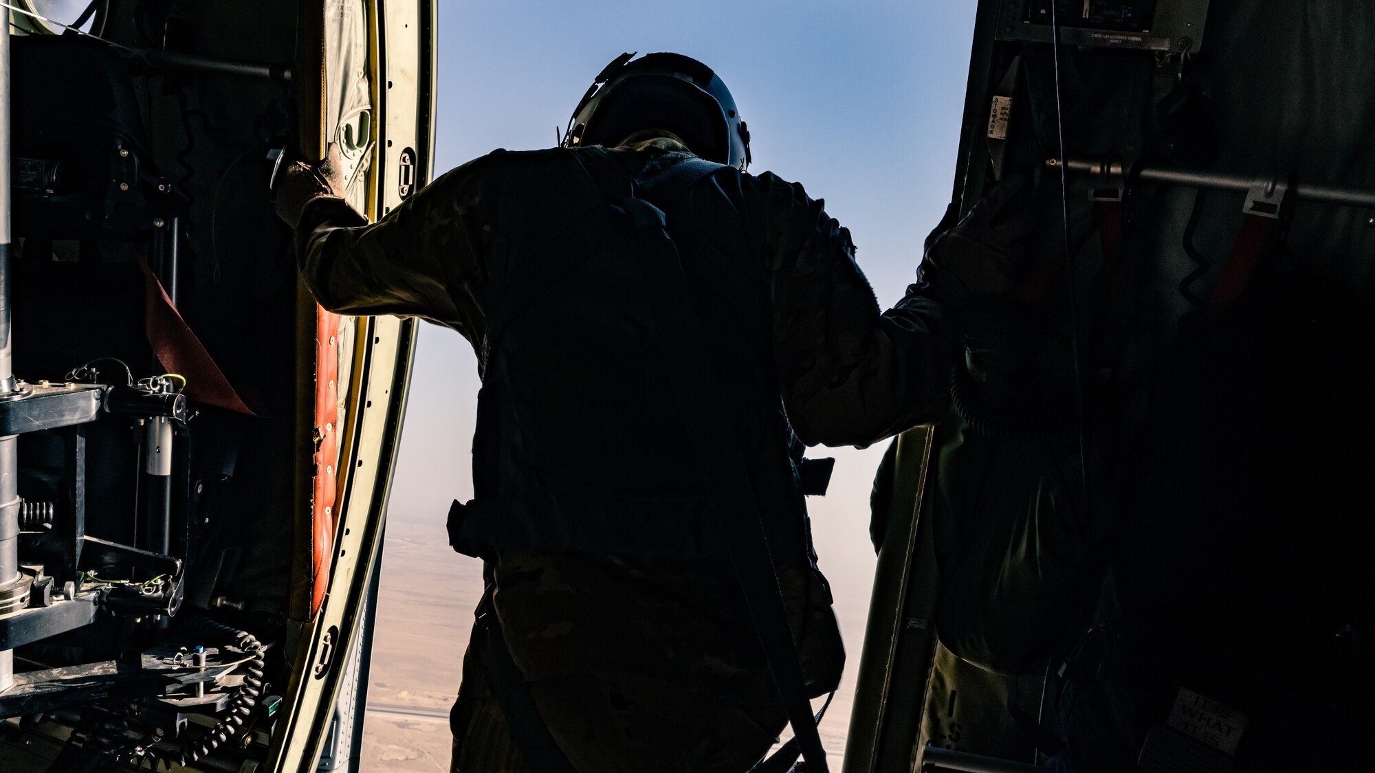 A U.S. Air Force loadmaster assigned to the 61st Expeditionary Airlift Squadron at the 386th Air Expeditionary Wing performs a safety check on the exit of a C-130J Super Hercules during an airborne operation over Egypt in support of exercise Bright Star 23, Sept. 7, 2023. Bright Star 23 is a multilateral U.S. Central Command exercise held with the Arab Republic of Egypt across air, land, and sea domains that promotes and enhances regional security and cooperation, and improves interoperability in irregular warfare against hybrid threat scenarios. (U.S. Air Force photo by Staff Sgt. Kevin Long)