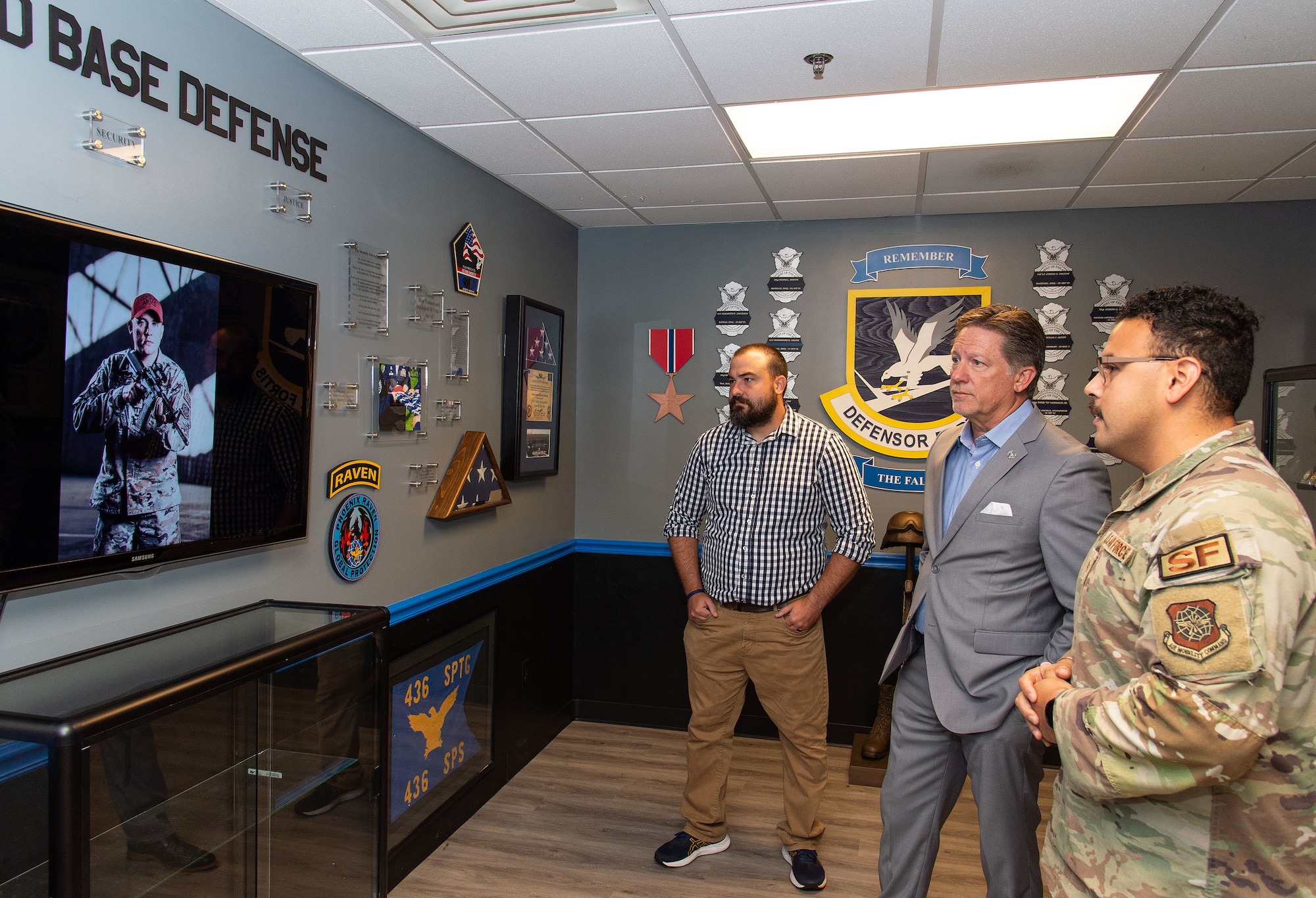 From the right, Staff Sgt. Michael Marquez, 436th Security Forces Squadron trainer, Chris Locke, founder of SL24: UnLocke the Light Foundation, and Zach Ryan, executive director of SL24, watch a video in the 436th SFS heritage room at Dover Air Force Base, Delaware, Aug. 29, 2023. Locke and Ryan met with Team Dover Airmen to get a better understanding of what they do on a daily basis, find out what their needs are and offer help to those suffering from depression and suicidal ideations. (U.S. Air Force photo by Roland Balik)