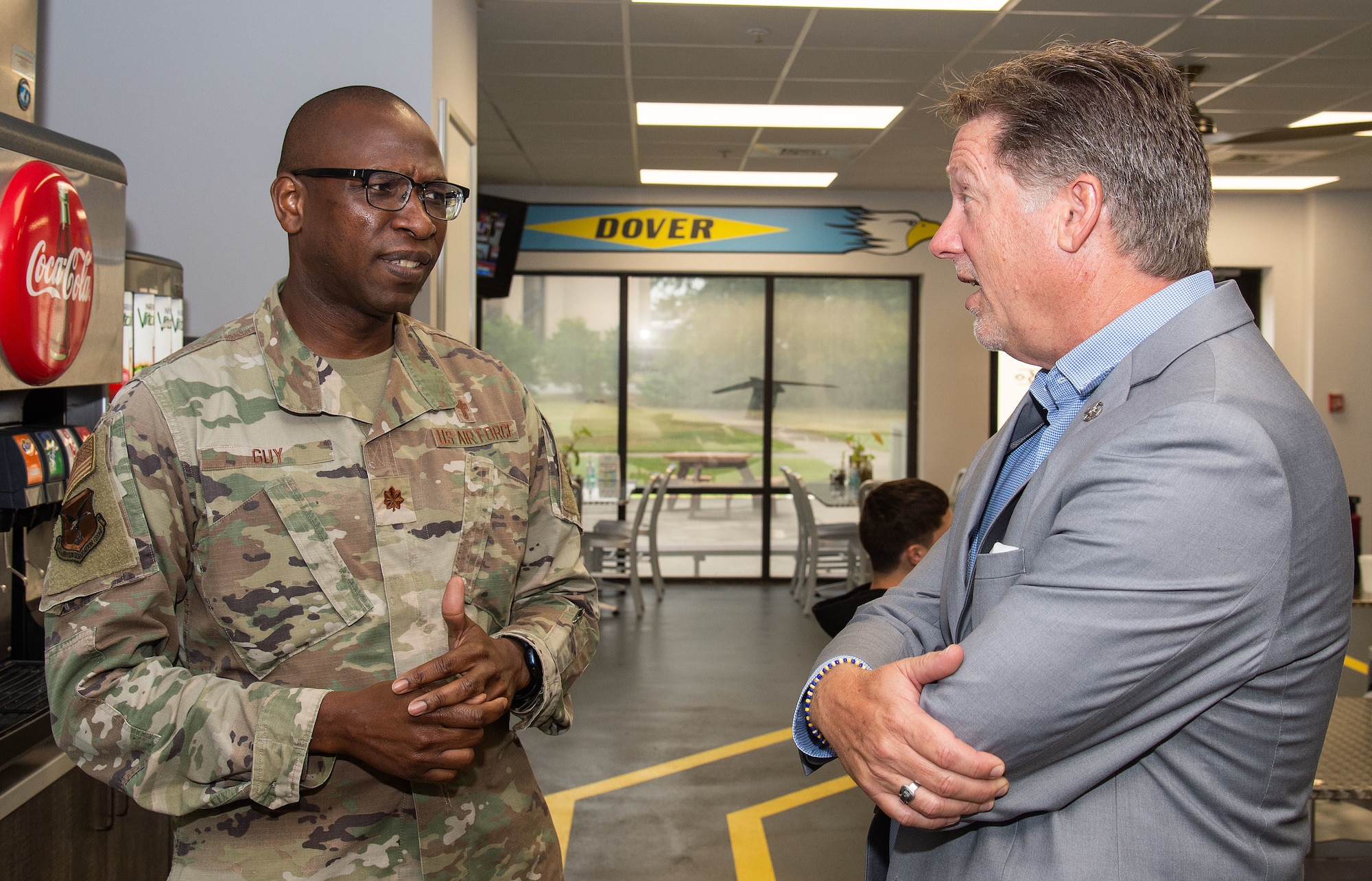 Chaplain (Maj.) William Guy, 436th Airlift Wing chaplain, speaks with Chris Locke, founder of SL24: UnLocke the Light Foundation, inside of a dining facility at Dover Air Force Base, Delaware, Aug. 29, 2023. Locke talked with Team Dover Airmen and leadership to get a better understanding of what they do on a daily basis, find out what their needs are and offer help to those suffering from depression and suicidal ideations. (U.S. Air Force photo by Roland Balik)