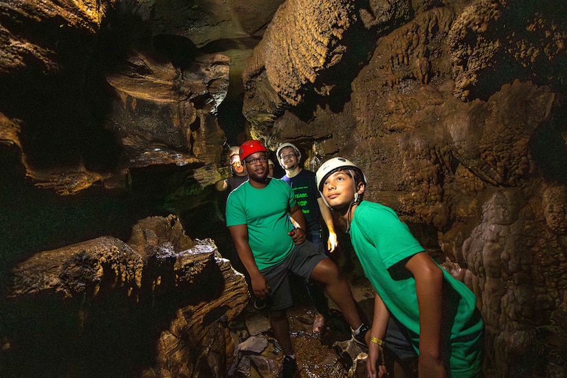 Campers explore a cave during the 2023 Kentucky National Guard Youth Camp at Lake Cumberland 4-H Education Center.