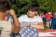 Campers raise the U.S. flag during the 2023 Kentucky National Guard Youth Camp.