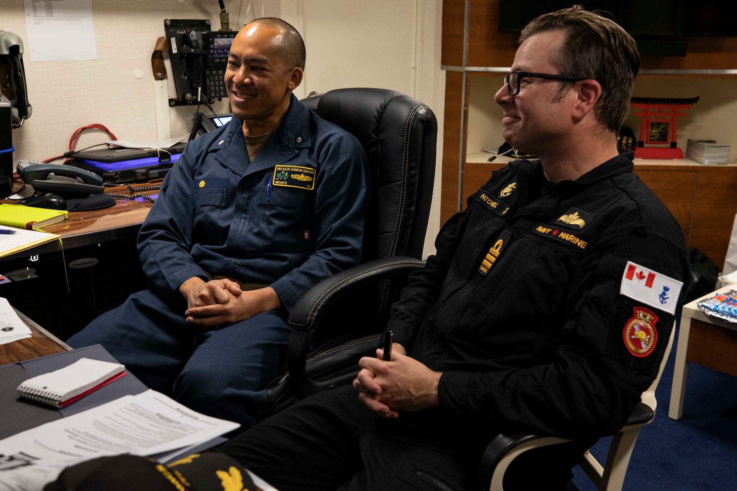 Cmdr. Isaia Infante, left, commanding officer of Arleigh Burke-class guided-missile destroyer USS Ralph Johnson (DDG 114) and Cmdr. Sam Patchell, right, commanding officer of His Majesty’s Canadian Ship (HMCS) Ottawa (FFH 341) conduct a meeting during a visit to Ralph Johnson Sep. 6 in the South China Sea. Ralph Johnson is assigned to Commander, Task Force 71/Destroyer Squadron (DESRON) 15, the Navy’s largest forward-deployed DESRON and the U.S. 7th Fleet’s principal surface force.