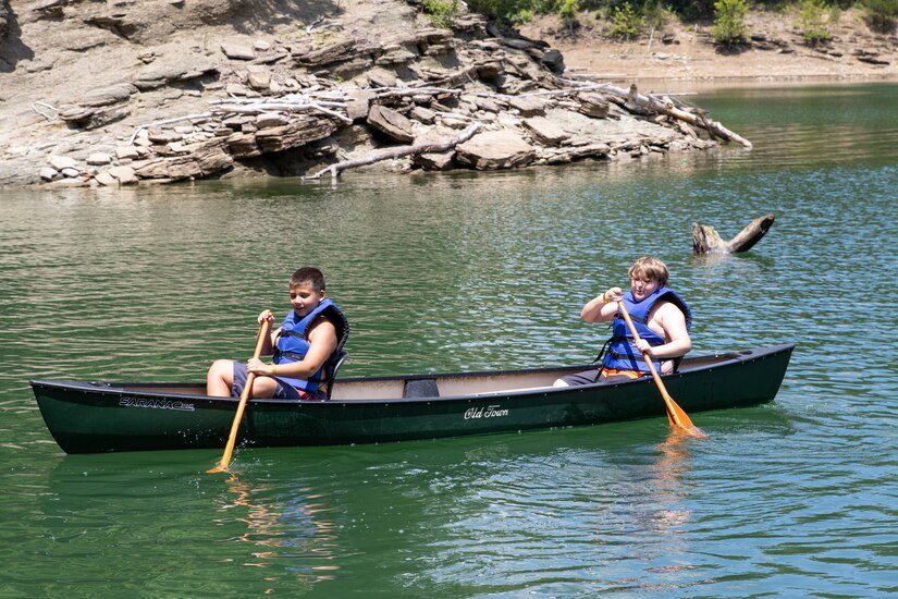 Two campers row a canoe at the Kentucky National Guard Youth Camp at Lake Cumberland 4-H Education Center in Nancy, Kentucky, July 31, 2023.