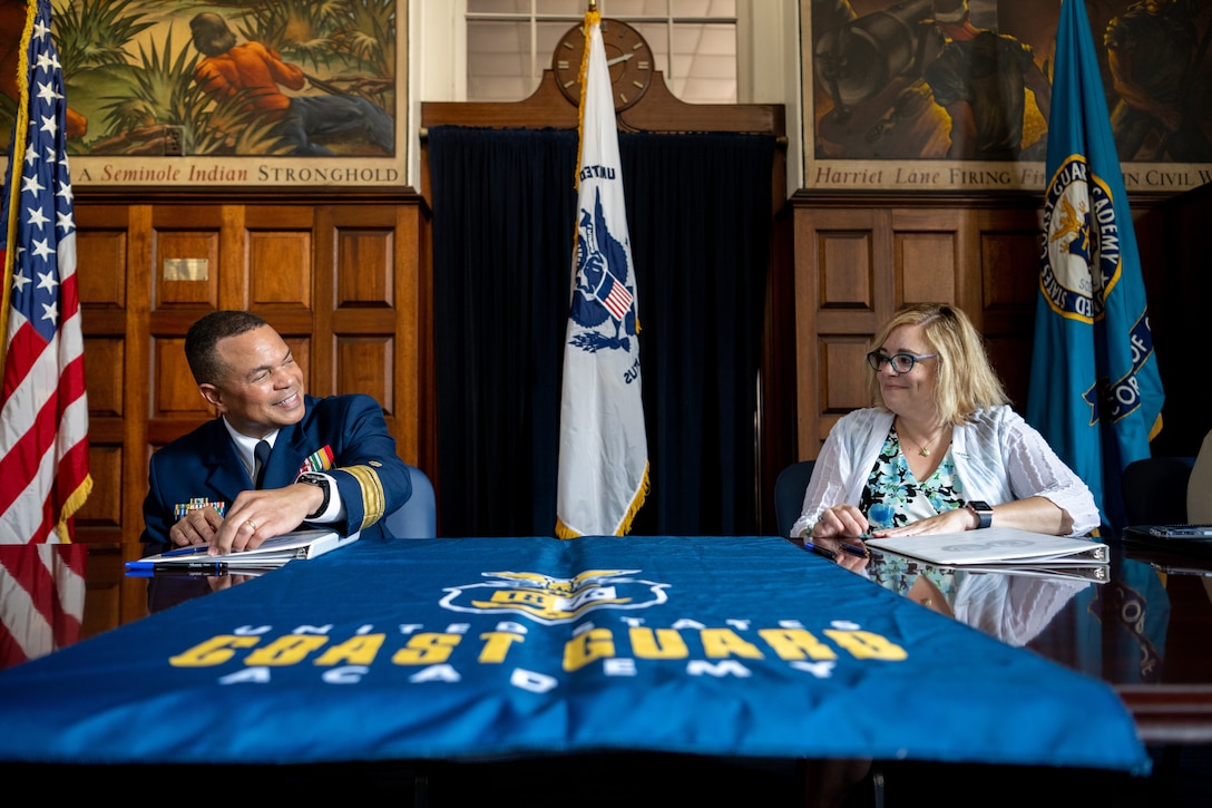 Academy Superintendent Rear Adm. Michael Johnston and UConn Avery Point Campus Director Dr. Annemarie Seifert sign an agreement establishing a STEM pilot program between the two institutions.  U.S. Coast Guard Photo by: PA2 Taylor Bacon.