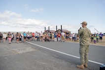 Lt. Cmdr. Sam Clement, executive officer, Naval Magazine Indian Island, speaks to race participants at Naval Magazine Indian Island during the Deer Run in Port Hadlock, Washington, August 13, 2022. About 150 runners and walkers participated in this year’s 5k and 1-mile Deer Run, which NMII typically hosts every year in the summer. (U.S. Navy photo by Mass Communication Specialist Seaman Apprentice Sophia H. Brooks)