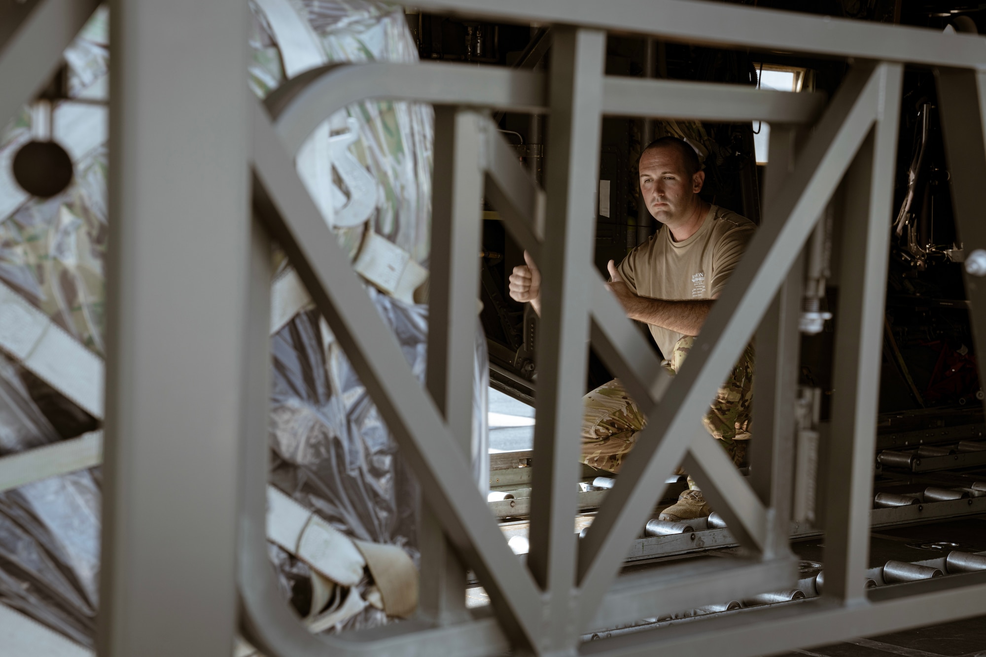 A 700th Airlift Squadron loadmaster gives directions as a pallet of gear is loaded onto a C-130 Hercules aircraft at Dobbins Air Reserve Base, Ga, on Sept. 8, 2023. The gear was being loaded in preparation for the Rally in the Pacific exercise, which is geared towards incorporating agile combat employment concepts in order to ensure that forward-deployed forces are ready to protect and defend the U.S. and to ensure that U.S. forces are capable and ready to face the evolving challenges within the Indo-Pacific region. (U.S. Air Force photo by MSgt. Miles Wilson)