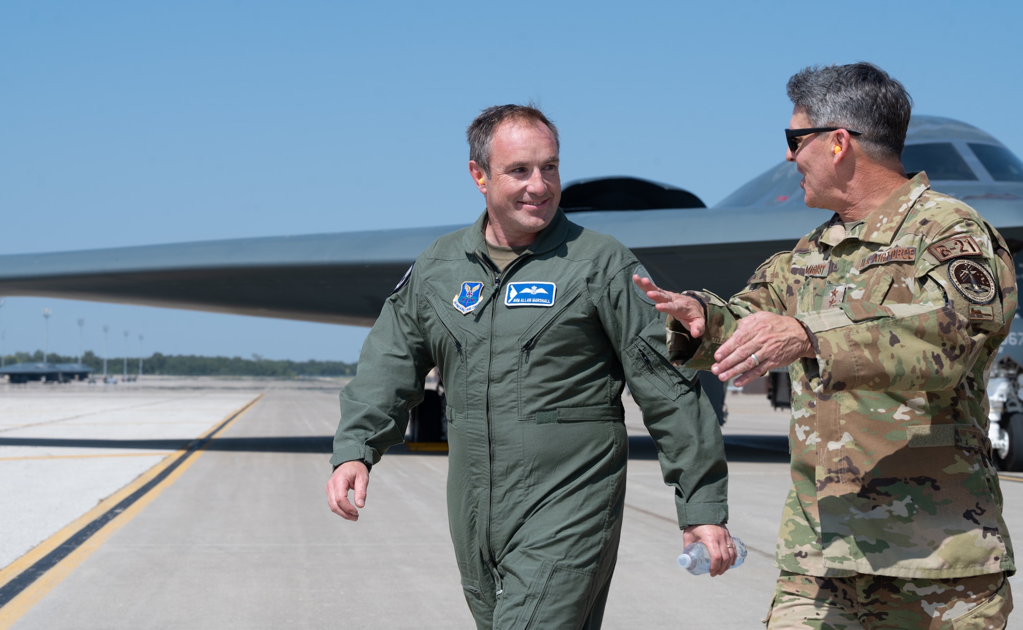 Royal Air Force Air Vice-Marshal Allan Marshall, Ministry of Defense assistant chief of defense staff, left, and U.S. Air Force Maj. Gen. Jason Armagost, 8th Air Force commander, right, walk in front of a U.S. Air Force B-2 Spirit stealth bomber at Whiteman Air Force Base, Mo., Sept. 8, 2023. Marshall’s visit was to get a better understanding of the B-2’s capabilities to penetrate an adversary's most sophisticated defenses. (U.S. Air Force photo by Airman 1st Class Joseph)