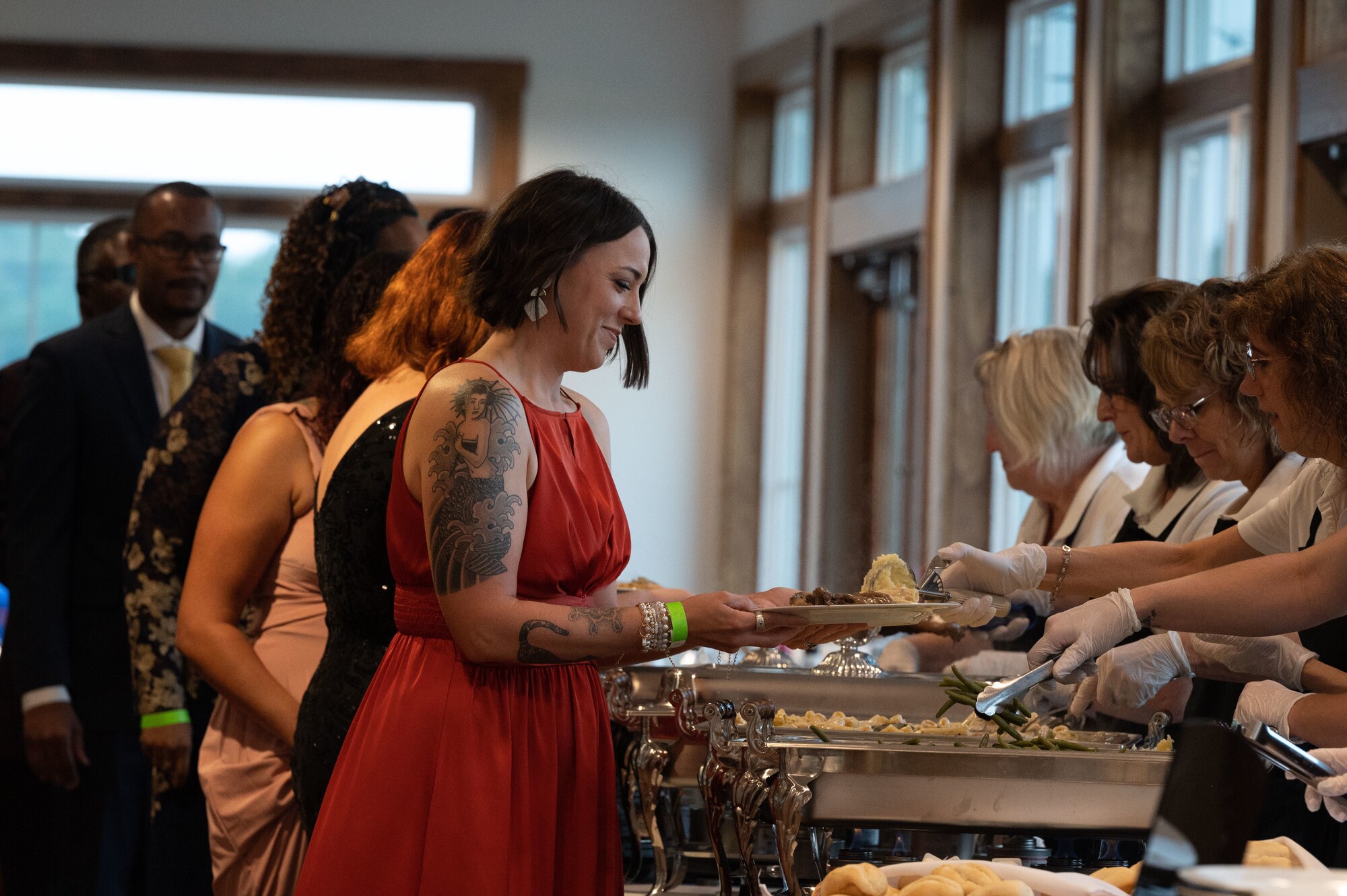 Team Dover members walk through a buffet line, during the 76th Air Force Ball in Dover, Delaware, Sept. 8, 2023. The Dover AFB Air Force Ball celebrated the 76th anniversary of the U.S. Air Force. (U.S. Air Force photo by Airman 1st Class Dieondiere Jefferies)