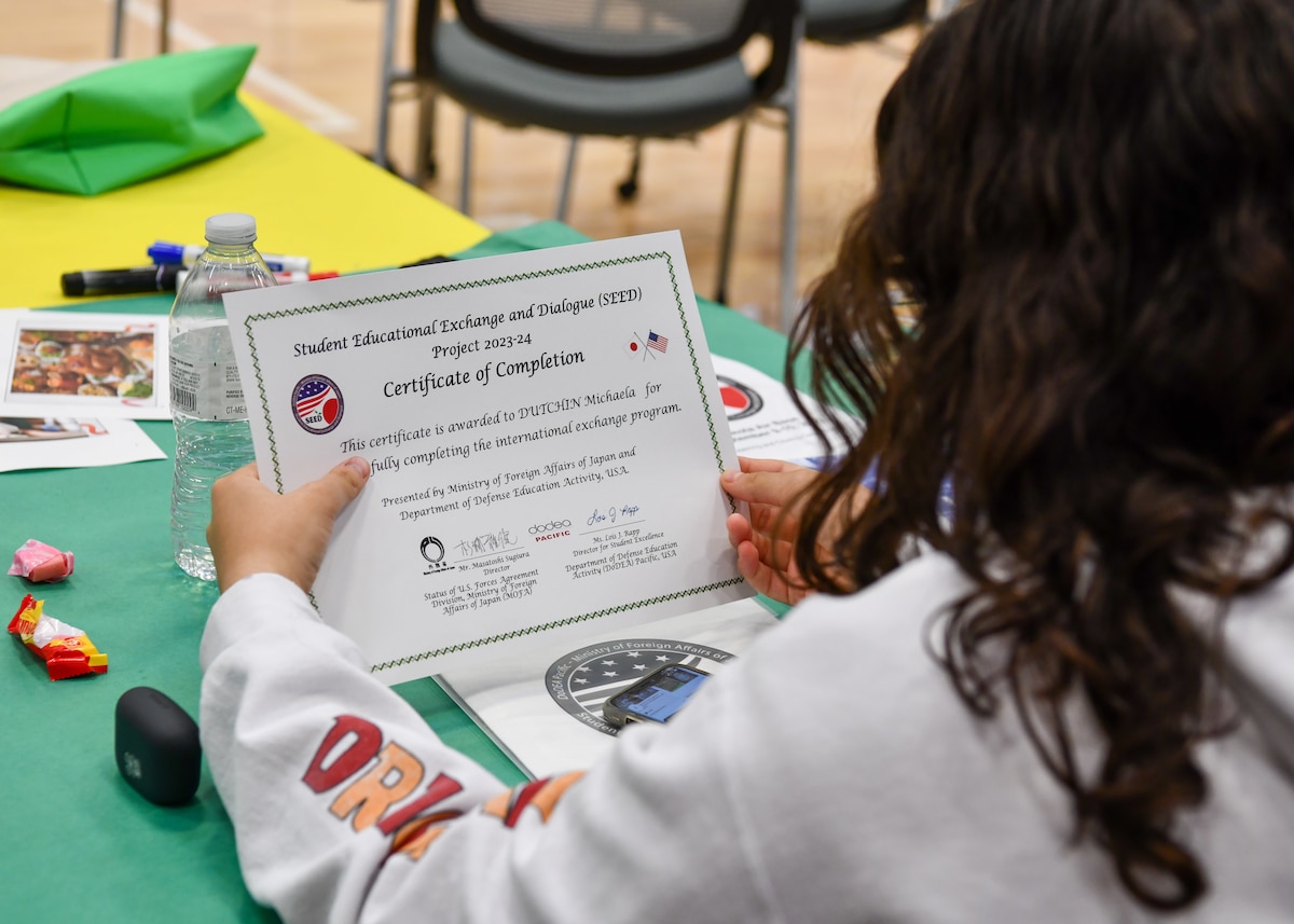 A Yokota Middle School student holds a certificate of completion during the Student Educational Exchange and Dialogue (SEED) project at Yokota Air Base, Japan, Sept. 10, 2023. SEED is a two-day event where students partake in educational activities designed to foster diverse perspectives, promote mutual understanding, bridge language barriers, and form deeper cross-cultural connections. (U.S. Air Force photo by Staff Sgt. Spencer Tobler)