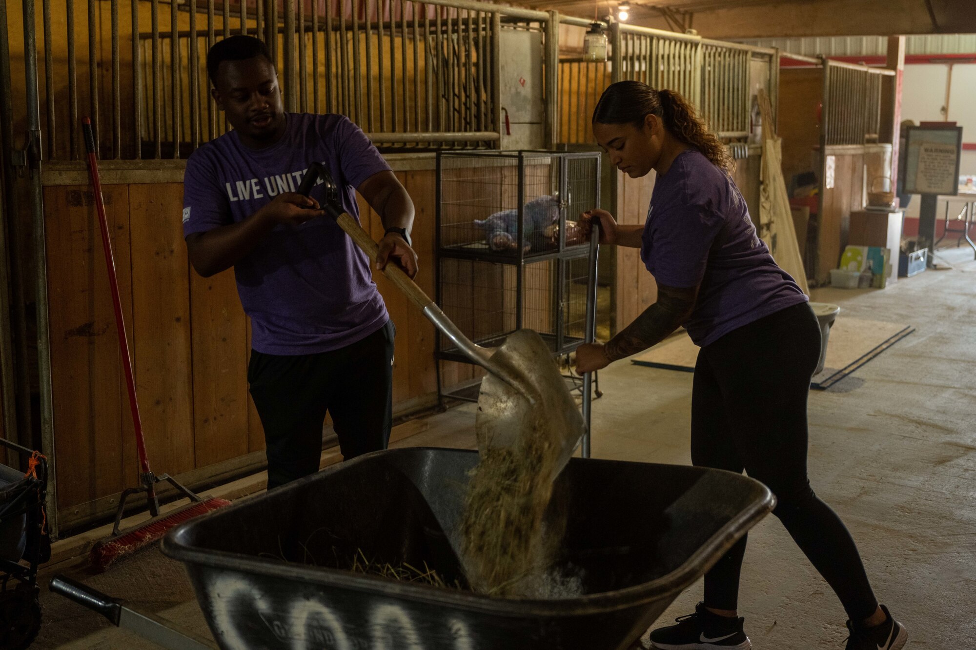 Airman 1st Class Jarvis Jackson (Left) and Airman 1st Class Chantelle Williams from the 34th Bomb Squadron on Ellsworth Air Force Base, clean horse stables at The Barn in Rapid City, South Dakota, Sept. 7, 2023. Many squadrons on Ellsworth including the 34th BS, the 89th Attack Squadron, 28th Munitions Squadron, 28th Operations Support Squadron and the 28th Maintenance Squadron participated for various volunteer opportunities in the community. (U.S. Air Force photo by Spc3 Adam Olson)