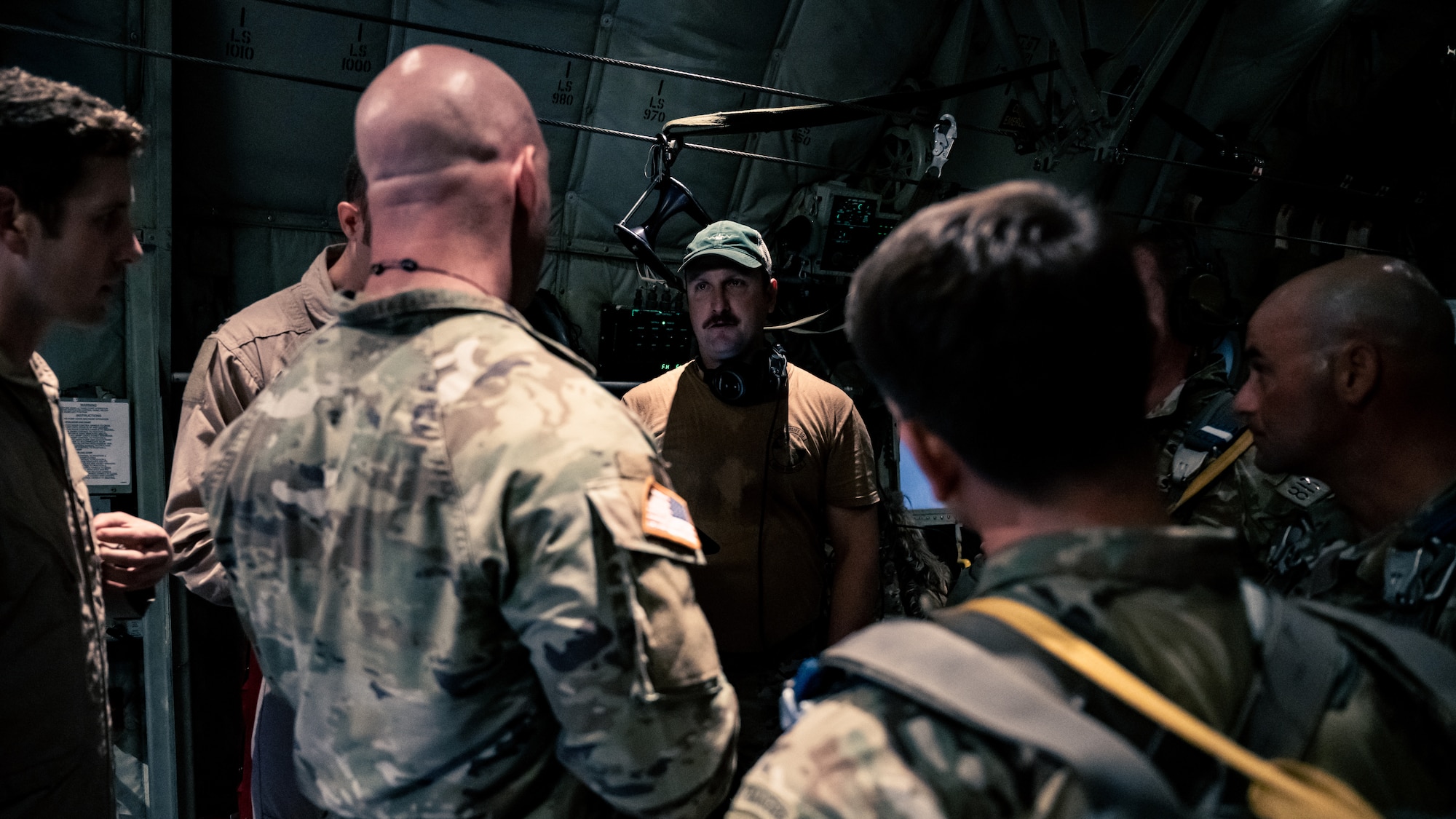 Texas Army National Guard Soldiers assigned to the 1st Battalion, 143rd Infantry Airborne Regiment, receive a pre-flight brief from a U.S. Air Force loadmaster assigned to the 386th Air Expeditionary Wing before conducting an airborne operation over Egypt in support of exercise Bright Star 23, Sept. 7, 2023. Bright Star 23 is a multilateral U.S. Central Command exercise held with the Arab Republic of Egypt across air, land, and sea domains that promotes and enhances regional security and cooperation, and improves interoperability in irregular warfare against hybrid threat scenarios. (U.S. Air Force photo by Staff Sgt. Kevin Long)