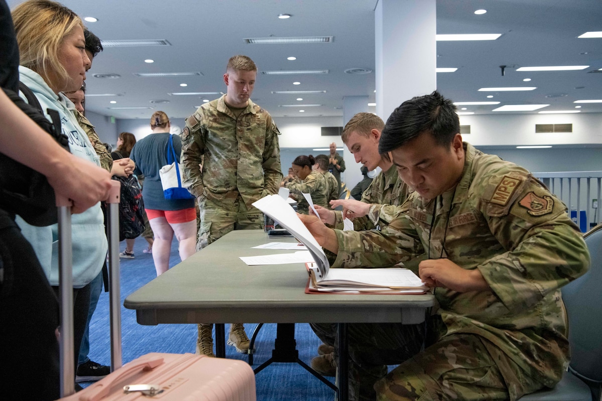 A military member looks through a folder.