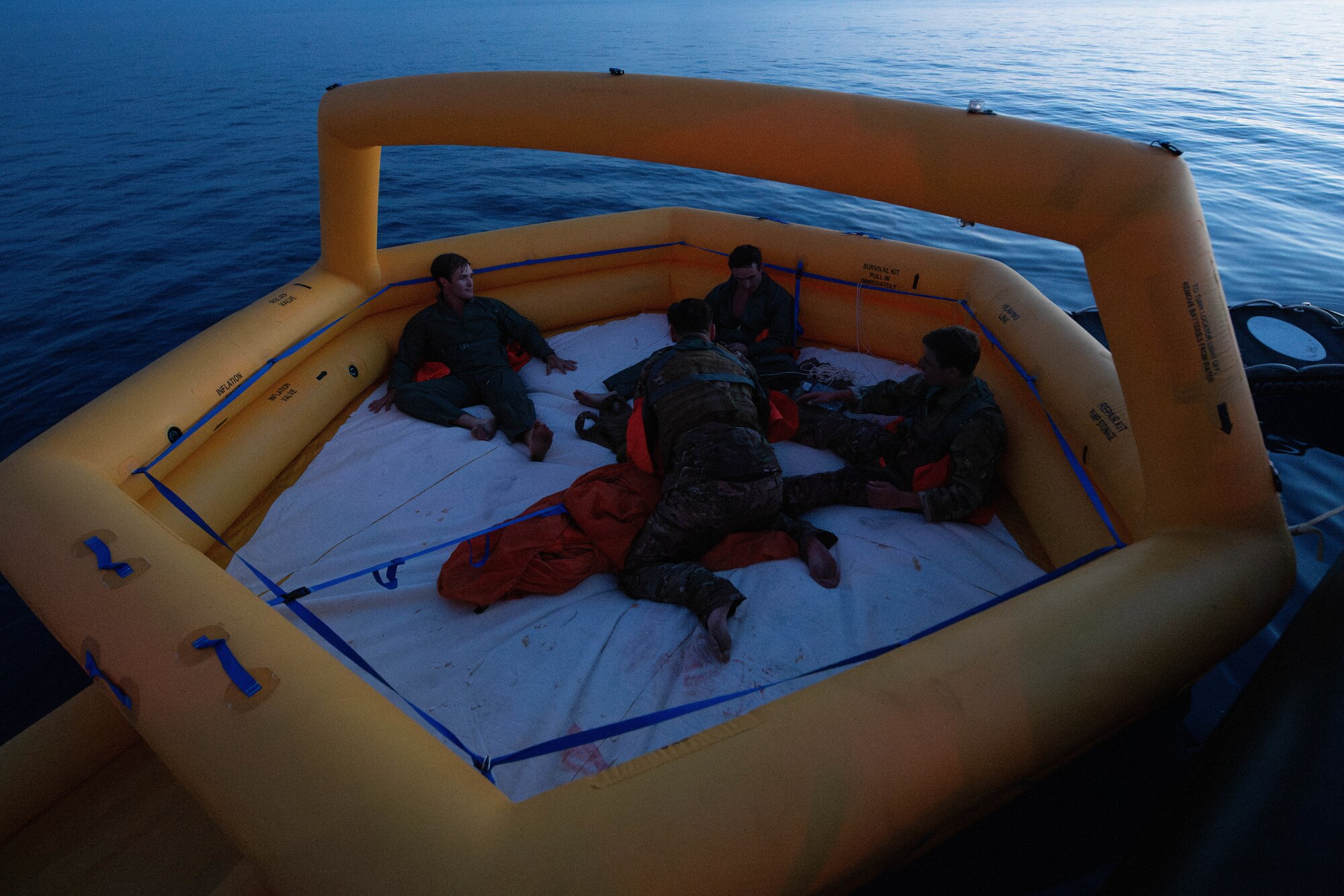 Airman sit on rescue raft