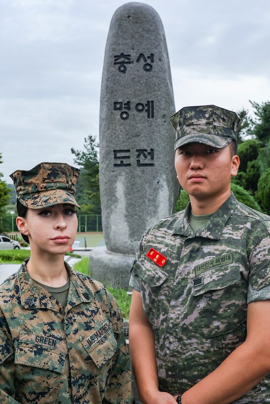 Republic of Korea Marine Cpl. Andrew Kim poses for a photo in front of the ROK Marine Corps emblem at Camp Baran, Republic of Korea Marine Corps Headquarters during Exercise Ulchi Freedom Shield 23. Kim, a Daegu, South Korea native, served as a translator on the watch floor of the operations center during UFS 23. Ulchi Freedom Shield is an annual exercise designed to strengthen the combined defense posture and Alliance response capabilities based on scenarios that reflect diverse threats within the security environment. This creates an opportunity for ROK and III MEF Marines to train together while conducting the live, virtual, and constructive exercise events that reaffirming the U.S.’s ironclad commitment to the defense of the ROK. (U.S. Marine Corps photo by Maj. Gabriel Adibe)