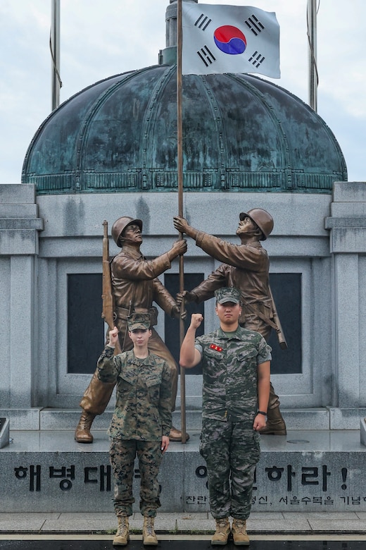 U.S. Marine Corps Sgt. Sophia Green and Republic of Korea Marine Cpl.l Andrew Kim pose for a photo in front of the flagpole and monument at Camp Baran, Republic of Korea Marine Corps Headquarters, during Exercise Ulchi Freedom Shield 23. Green, a San Diego, Calif., native served as the Camp Commandant for UFS 23. Kim, a Daegu, South Korea native, served as a translator on the watch floor of the operations center during UFS 23. Ulchi Freedom Shield is an annual exercise designed to strengthen the combined defense posture and Alliance response capabilities based on scenarios that reflect diverse threats within the security environment. This creates an opportunity for ROK and III MEF Marines to train together while conducting the live, virtual, and constructive exercise events that reaffirming the U.S.’s ironclad commitment to the defense of the ROK. (U.S. Marine Corps photo by Maj. Gabriel Adibe)