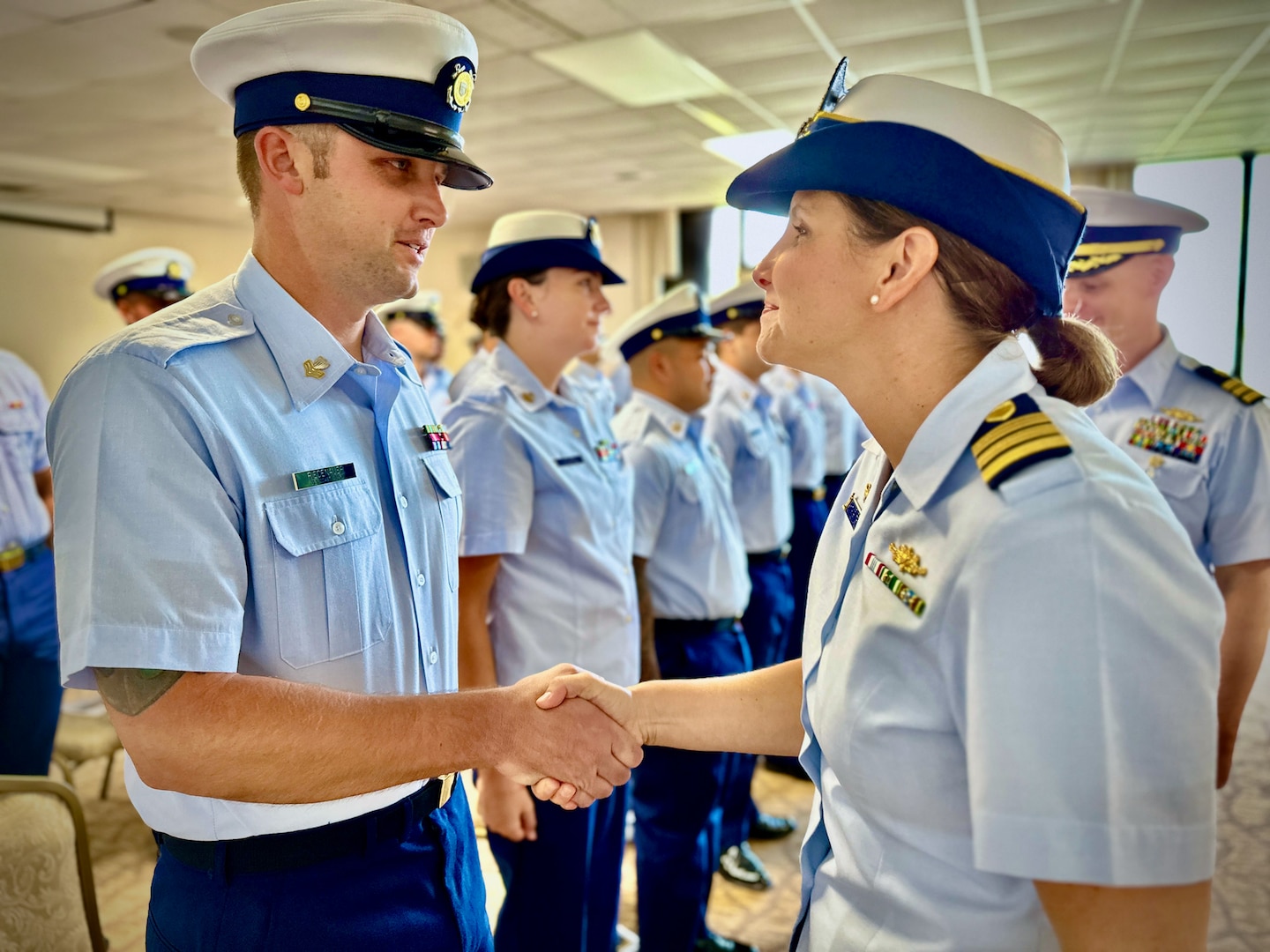 Cmdr. Linden Dahlkemper greets crew members during the final inspection of the USCGC Hickory (WLB 212) crew in a change of command ceremony held at the Top o’the Mar in Guam on Wednesday, Sep. 13, 2023. The ceremony also signaled the official shift of the 225-foot seagoing buoy tender in Guam from USCGC Sequoia (WLB 215), currently at its major maintenance availability (MMA) at the U.S. Coast Guard Yard in Baltimore, to USCGC Hickory, which is just completing MMA and will now serve the Western Pacific. (U.S. Coast Guard photo by Chief Warrant Officer Sara Muir)