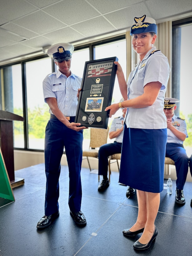 Cmdr. Linden Dahlkemper accepts her commissioning pennant for USCGC Sequoia (WPB 215) in a change of command ceremony held at the Top o’the Mar in Guam on Wednesday, Sep. 13, 2023. The ceremony also signaled the official shift of the 225-foot seagoing buoy tender in Guam from USCGC Sequoia (WLB 215), currently at its major maintenance availability (MMA) at the U.S. Coast Guard Yard in Baltimore, to USCGC Hickory, which is just completing MMA and will now serve the Western Pacific. (U.S. Coast Guard photo by Chief Warrant Officer Sara Muir)