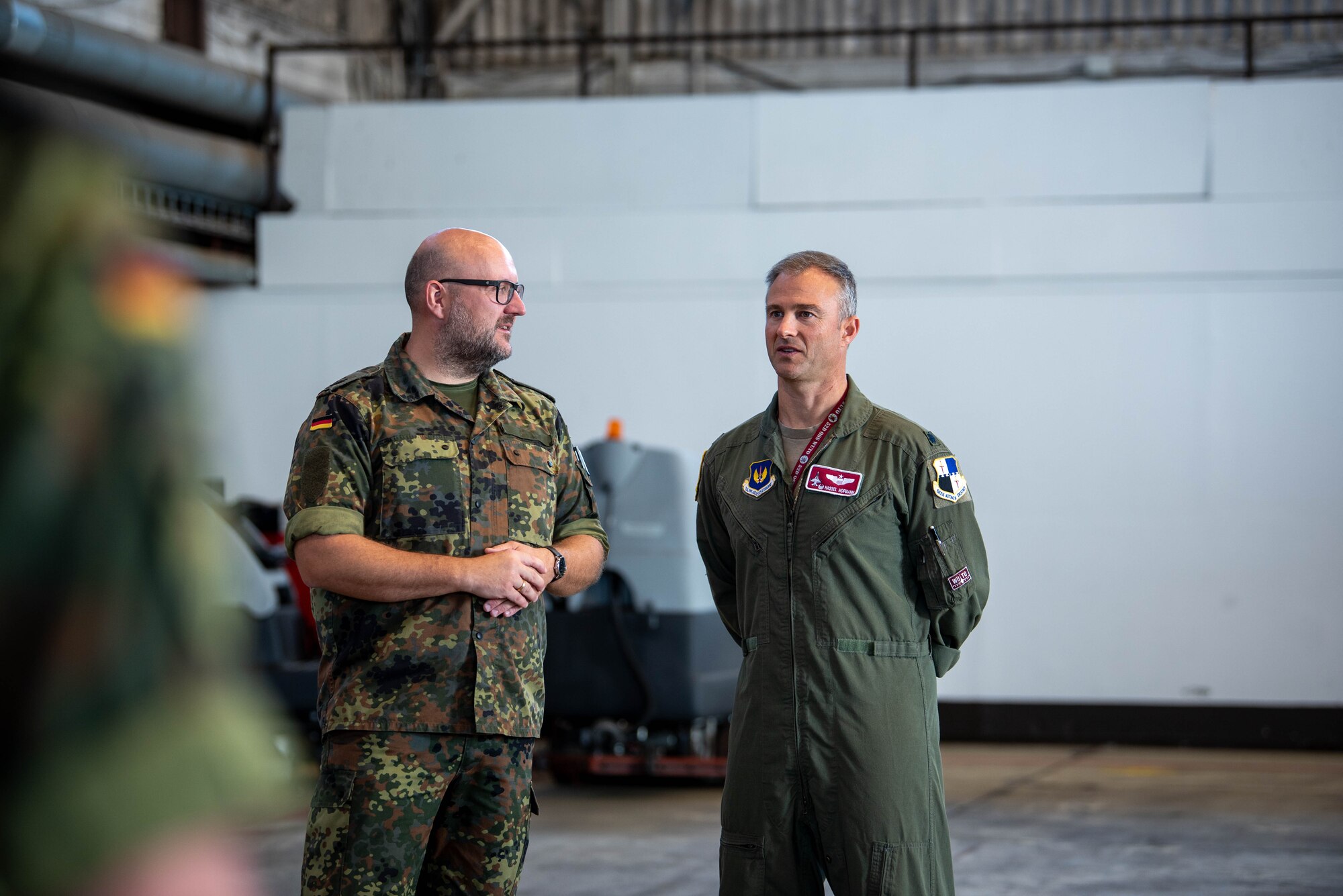 German Bundeswehr Lt. Col. Rafael Intek, Electronic Warfare Battalion 931, Electronic Reconnaissance Squadron commander, speaks with U.S. Air Force Lt. Col. Nathaniel Hofmann, 52nd Operations Support Squadron commander, during a base tour, Sept. 6, 2023, at Spangdahlem Air Base, Germany.