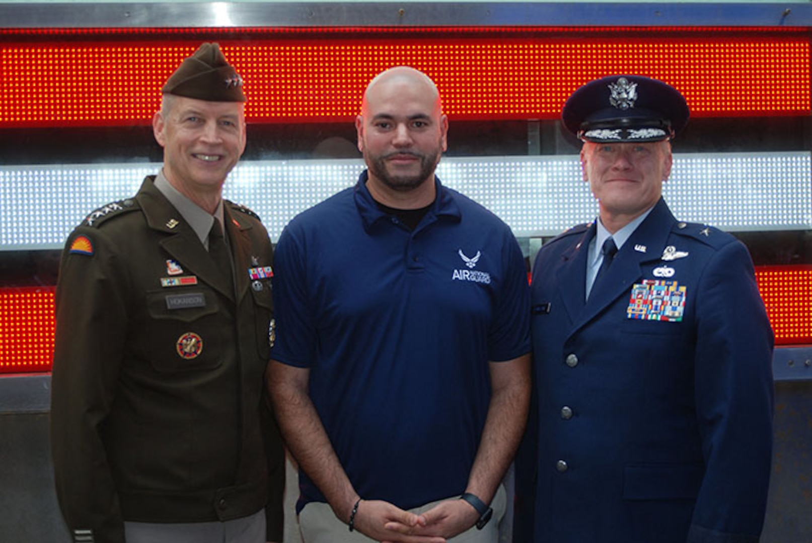 Army General Dan Hokanson, Chief of the National Guard Bureau, poses with Brig. Gen. Gary Charlton, commander of the New York Air National Guard's 105th Airlift and the wing’s newest member, Airman William Barrow, a former FDNY firefighter who served at the World Trade Center on 9/11 following his oath of service ceremony at the Time Square Recruiting Station in New York, September 11, 2023.
