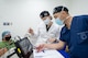 Two ophthalmologists review a patient's ocular biometry eye test results during preoperative care in Panama.