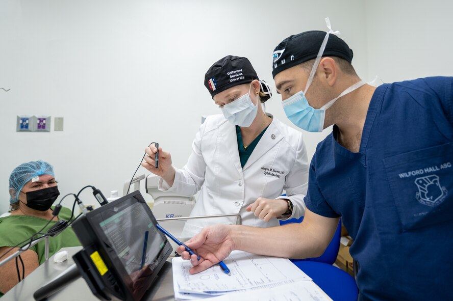 Two ophthalmologists review a patient's ocular biometry eye test results during preoperative care in Panama.