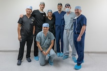 A group photo of ophthalmologists and medical technicians after completing a successful day of surgeries.