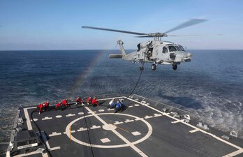 USS Dewey (DDG 105) in-flight refueling with HSM-37 in the Philippine Sea.