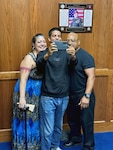 (Center) Christian Castro, Navy applicant, poses for a photo with his parents following his Oath of Enlistment at Tampa MEPS. USMEPCOM recently released policy allowing two guests per applicant about to ship to basic training, as well as National Guard and Reserve component applicants.
