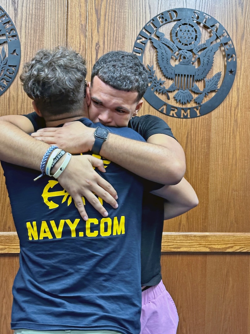 (L) Kevin Cruz hugs his younger brother Bryan before shipping to Navy basic training from Tampa MEPS. USMEPCOM recently released policy allowing two guests per applicant about to ship to basic training, as well as National Guard and Reserve component applicants.