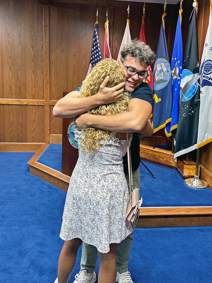 Kevin Cruz embraces his mother, Lunice, before shipping to Navy basic training from Tampa MEPS. USMEPCOM recently released policy allowing two guests per applicant about to ship to basic training, as well as National Guard and Reserve component applicants.