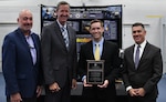 IMAGE: Stephen Cricchi, SES, Executive Director of Naval Air Warfare Center Aircraft Division (NAWCAD), Deputy Assistant Secretary of the Navy Dr. Brett Seidle, SES, and Naval Surface Warfare Center Dahlgren Division (NSWCDD) Technical Director Dale Sisson Jr., SES, stand with Tyler Winningham (third from left) of NAWCAD after he received the G. Dennis White Early Career Human Systems Integration Practitioner Award Sept. 5 at NSWCDD.