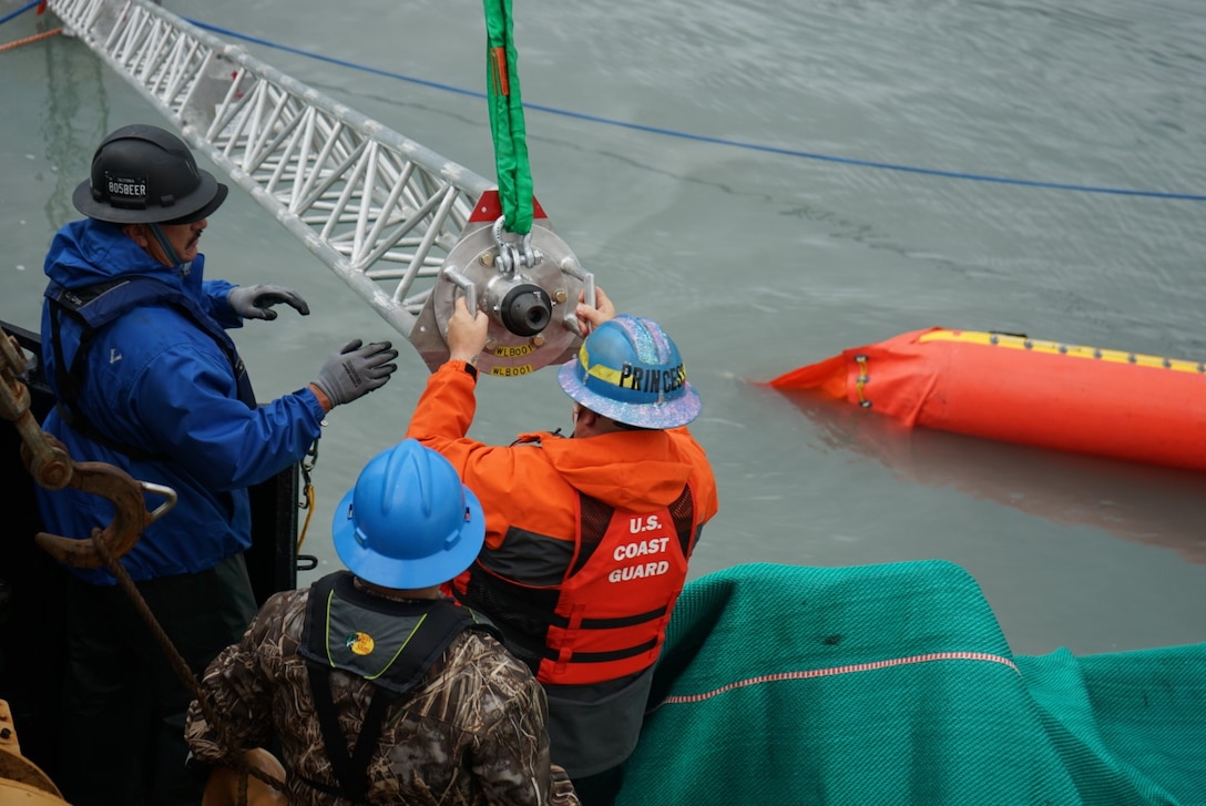 U.S. Coast Guard and U.S. Navy Supervisor of Salvage and Diving members test pollution containment and collection equipment near Seward, Alaska, Aug. 30, 2023.