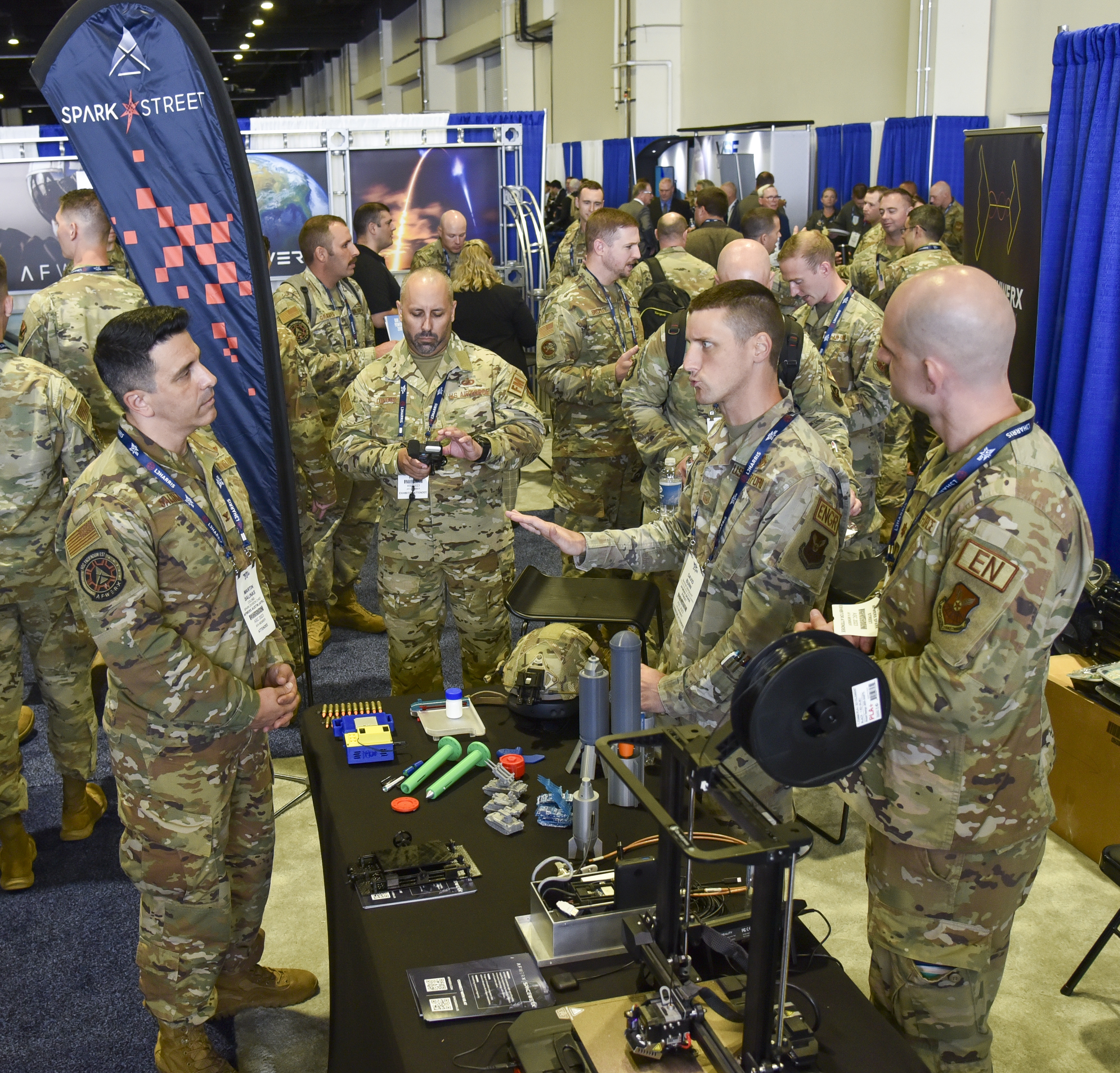 Master Sgt. David Bunn, AFWERX Spark Street booth exhibiitor, briefs Col. Martin Salinas, AFWERX Spark division chief, at the Air, Space and Cyber Conference at the Gaylord National Resort and Convention Center in National Harbor, Maryland, Sept. 11, 2023. Spark, an AFWERX division, connects Airmen and Guardian operators to commercial innovators and acquisition processes. Spark Street, a custom set of four booth spaces, will showcase nearly 20 Spark Cells from around the world. (U.S. Air Force photo by Matthew Clouse)