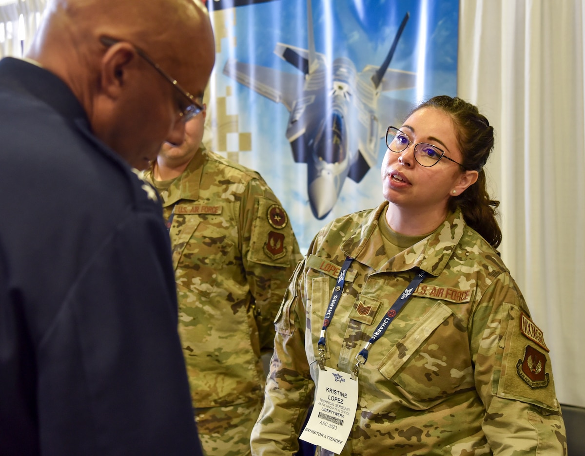 Tech. Sgt. Kristine Lopez, Spark Street LibertyWERX booth exhibitor, gives a technology demonstation to Gen. CQ Brown Jr., Air Force Chief of Staff, at the Air, Space and Cyber Conference at the Gaylord National Resort and Convention Center in National Harbor, Maryland, Sept. 12, 2023. Spark Street, a custom set of four booth spaces, showcased nearly 20 Spark Cells from around the world. Spark, an AFWERX division, connects Airmen and Guardian operators to commercial innovators and acquisition processes. (U.S. Air Force photo by Matthew Clouse)